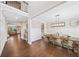 Open-concept dining room features hardwood floors, wainscoting, a modern light fixture, and a view of the living area at 1599 Benham Dr, Snellville, GA 30078