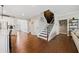 Elegant entryway with hardwood floors, stairs, stainless steel fridge, and white trim throughout at 1599 Benham Dr, Snellville, GA 30078