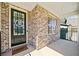 Welcoming front porch with brick exterior and a decorative door at 1599 Benham Dr, Snellville, GA 30078