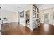 Inviting hallway with hardwood floors leading to a laundry area and other rooms at 1599 Benham Dr, Snellville, GA 30078