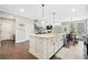 Spacious kitchen featuring a large island, white cabinets, modern appliances, and an open layout at 1599 Benham Dr, Snellville, GA 30078