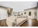 Spacious living room with a plush sofa and luxury vinyl flooring, leading to the kitchen at 1599 Benham Dr, Snellville, GA 30078