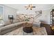 Spacious living room features a cozy sectional, a round coffee table, and an area rug at 1599 Benham Dr, Snellville, GA 30078