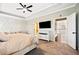Spacious main bedroom featuring tray ceilings, neutral colors, and a mounted television at 1599 Benham Dr, Snellville, GA 30078