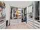 Spacious walk-in closet featuring custom shelves, drawers and storage for clothes and shoes at 1599 Benham Dr, Snellville, GA 30078