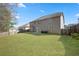 A spacious backyard with a well-maintained lawn and privacy fence on a sunny day at 7686 Brazos Trl, Fairburn, GA 30213