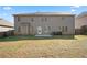 View of the home's backyard with green lawn at 7686 Brazos Trl, Fairburn, GA 30213
