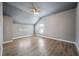 Neutral bedroom with vaulted ceiling, ceiling fan, gray walls, and wood-look floors at 7686 Brazos Trl, Fairburn, GA 30213