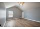 Neutral bedroom with vaulted ceiling, ceiling fan, window, gray walls and wood-look floors at 7686 Brazos Trl, Fairburn, GA 30213