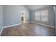 Well-lit bedroom with hardwood floors, neutral wall colors and large window at 7686 Brazos Trl, Fairburn, GA 30213