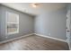 Neutral bedroom with window and door to the hallway at 7686 Brazos Trl, Fairburn, GA 30213