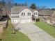 Lovely two-story home with a three-car garage, showcasing the well-maintained front yard at 7686 Brazos Trl, Fairburn, GA 30213