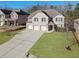 Charming two-story home with a three-car garage and a beautifully landscaped front lawn at 7686 Brazos Trl, Fairburn, GA 30213