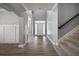 Bright foyer boasts hardwood floors, gray walls, white trim, and a staircase leading to the upper level at 7686 Brazos Trl, Fairburn, GA 30213