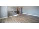 Upstairs hallway featuring hardwood floors, wrought iron decorative railing, and modern lighting at 7686 Brazos Trl, Fairburn, GA 30213
