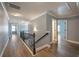 Upstairs hallway featuring hardwood floors, modern lighting and decorative railing at 7686 Brazos Trl, Fairburn, GA 30213