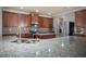 Spacious kitchen with granite countertops, stainless appliances, and wooden cabinets at 7686 Brazos Trl, Fairburn, GA 30213