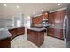 Spacious kitchen island with granite countertops, stainless appliances, and recessed lighting at 7686 Brazos Trl, Fairburn, GA 30213