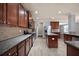 Gourmet kitchen with granite counters, stainless steel appliances, and dark wood cabinets at 7686 Brazos Trl, Fairburn, GA 30213