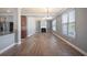 Spacious open living room with hardwood floors, fireplace, and abundant natural light at 7686 Brazos Trl, Fairburn, GA 30213