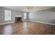 Bright living room with a cozy fireplace, ceiling fan, and natural light at 7686 Brazos Trl, Fairburn, GA 30213
