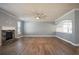 Bright living room with fireplace, crown molding, and large windows at 7686 Brazos Trl, Fairburn, GA 30213