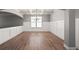 Spacious living room with hardwood floors, coffered ceilings, and large window at 7686 Brazos Trl, Fairburn, GA 30213