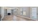 Inviting living room features a fireplace, hardwood floors, and large windows at 7686 Brazos Trl, Fairburn, GA 30213
