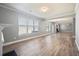 Large living area featuring abundant natural light and hardwood floors at 7686 Brazos Trl, Fairburn, GA 30213