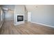 Spacious main bedroom featuring a fireplace, hardwood floors and modern lighting at 7686 Brazos Trl, Fairburn, GA 30213