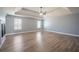 Spacious main bedroom with hardwood floors, modern ceiling fan, and double windows at 7686 Brazos Trl, Fairburn, GA 30213