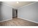 A light-filled room featuring neutral gray walls, white trim, and wood flooring at 7686 Brazos Trl, Fairburn, GA 30213