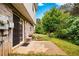 Brick home with sliding glass doors leading to a concrete patio and treed backyard at 905 Magnolia Gardens Walk, Mcdonough, GA 30253