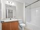 Well-lit bathroom with tub, neutral vanity, toilet, and a large mirror for daily routines at 905 Magnolia Gardens Walk, Mcdonough, GA 30253