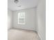 Light-filled bedroom with neutral paint, plush carpet, and a window that provides natural light at 905 Magnolia Gardens Walk, Mcdonough, GA 30253