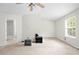 Cozy bedroom featuring neutral carpet, ceiling fan, and natural light to offer a comfortable retreat at 905 Magnolia Gardens Walk, Mcdonough, GA 30253