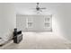 Spacious bedroom with neutral carpet, ceiling fan, and abundant natural light from two windows at 905 Magnolia Gardens Walk, Mcdonough, GA 30253