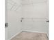 Walk-in closet with neutral carpet, white walls, and white, adjustable wire shelving at 905 Magnolia Gardens Walk, Mcdonough, GA 30253
