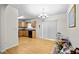 Open dining area with hardwood floors, chandelier, and sliding doors adjacent to the kitchen at 905 Magnolia Gardens Walk, Mcdonough, GA 30253