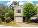Charming townhome with brick accents, a one-car garage and a well-maintained front yard with lush greenery at 905 Magnolia Gardens Walk, Mcdonough, GA 30253