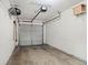 Clean, single car garage with white walls and ceiling shelving for storage at 905 Magnolia Gardens Walk, Mcdonough, GA 30253