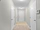 Inviting hallway with clean carpet and tile, leading to various rooms of the home at 905 Magnolia Gardens Walk, Mcdonough, GA 30253