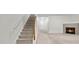 Comfortable living space with fireplace, carpeted floors, staircase and neutral tones at 905 Magnolia Gardens Walk, Mcdonough, GA 30253