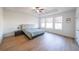Spacious bedroom with tray ceiling, wood floors, and three large windows offering abundant natural light at 171 Echols Bnd, Hiram, GA 30141