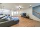 Open-concept living room with wood floors, modern furnishings, and abundant natural light from the door and windows at 171 Echols Bnd, Hiram, GA 30141