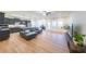 Bright living room with wood floors seamlessly connects to the kitchen, featuring modern furniture and plenty of natural light at 171 Echols Bnd, Hiram, GA 30141