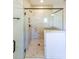 Modern walk-in shower with marble tiling, glass enclosure, built-in niche, and sleek black fixtures at 171 Echols Bnd, Hiram, GA 30141