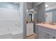 Well lit bathroom with white tub/shower combo, large mirror, and gray vanity at 3268 Rivermist Cv, Decatur, GA 30034