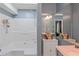 Well lit bathroom with white tub/shower combo, large mirror, and gray vanity at 3268 Rivermist Cv, Decatur, GA 30034