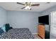 Bedroom showcasing light blue walls, ceiling fan and natural light from the window at 3268 Rivermist Cv, Decatur, GA 30034